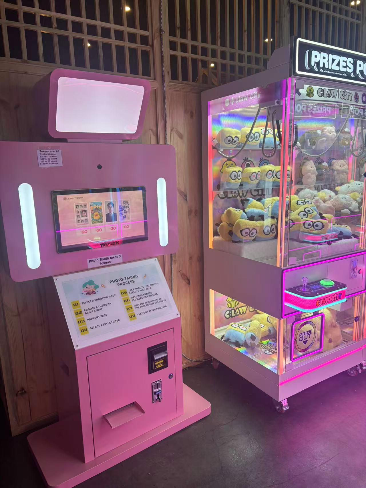 Pink photo booth and claw machine with Minions plush toys at Dough valley, a Ramen Restaurant in Oregon City